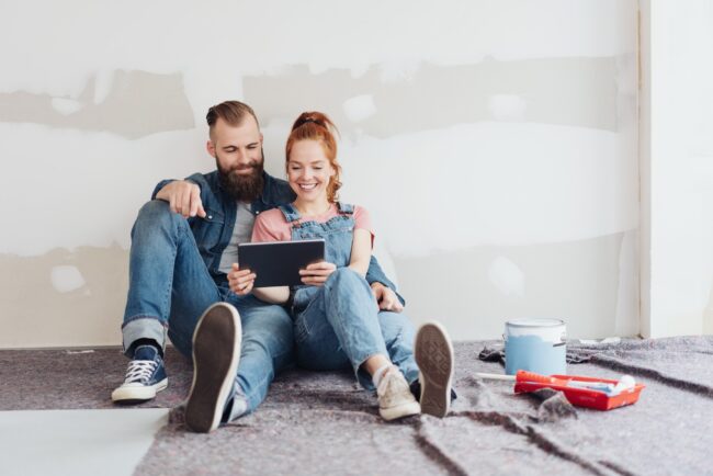 Young couple doing home renovations taking a break