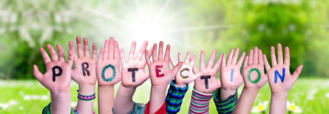 Kids Hands Holding Word Protection, Grass Meadow